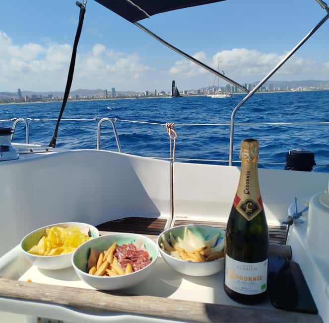 Barcelona Badalona : Sailboat Tour, Snacks, Drinks, Swimming - Sailing toward Barcelona’s skyline