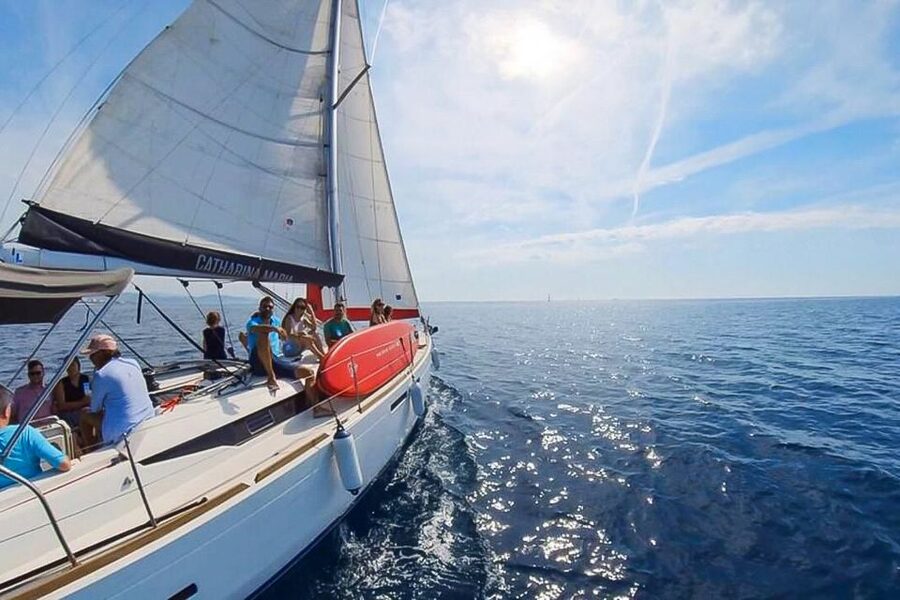 Barcelona: Coastline Boat Trip with Snacks and Cava - Boarding a small sailboat with a friendly crew