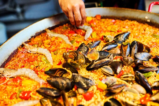 Barcelona Paella Cooking Class with Market Visit, Tapas & Sangria - Cooking paella with a local chef