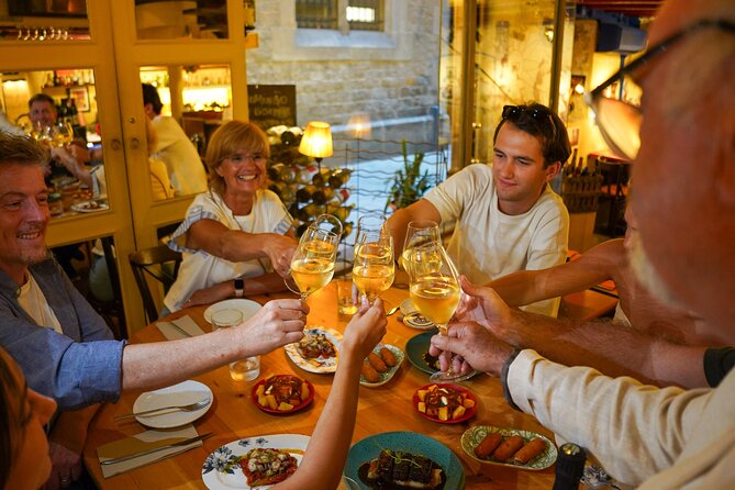Barcelona Tapas and Wine Experience Small-Group Walking Tour - Main dishes: canelon, black paella, and pork cheek