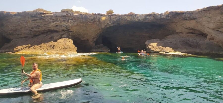 Ibiza: Sea Caves & Coves Snorkeling Paddle Boarding Tour - A boat designed for relaxing between swims