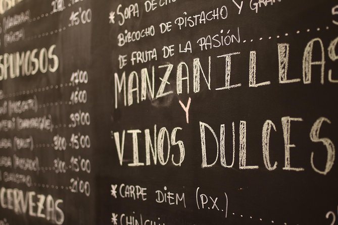 Malaga Wine & Tapas Small Group Guided Tour - Iberian ham in a traditional ultramarinos