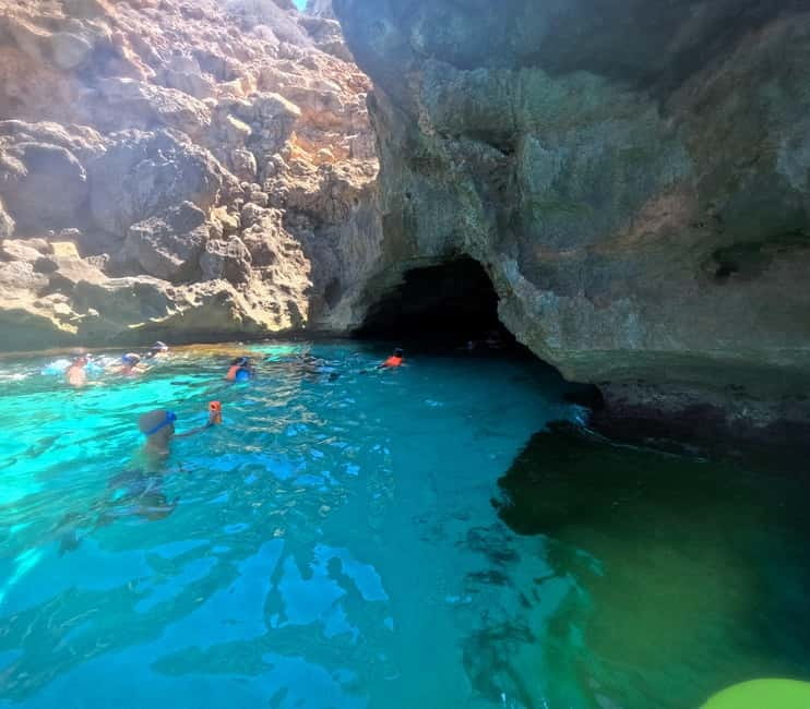 Mallorca: Sea Cave Kayaking Tour with Snorkeling and a Snack - Caves, cliffs, and water in changing shades of blue