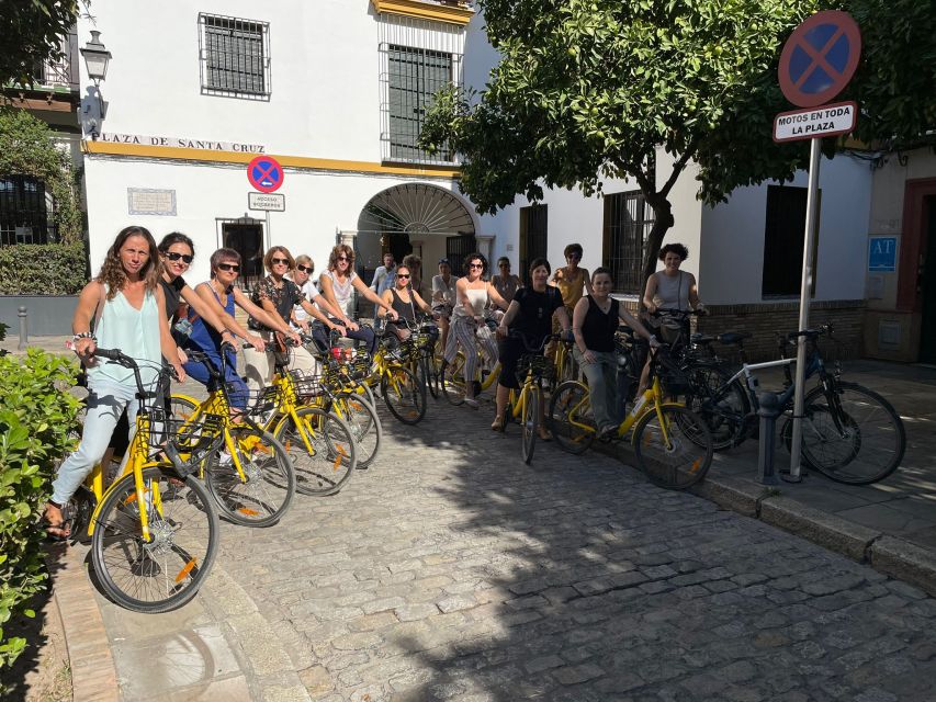 Seville: Relaxing City Bike Tour with a Tour Guide - The Antigua Fábrica de Tabacos and Seville’s grand architecture